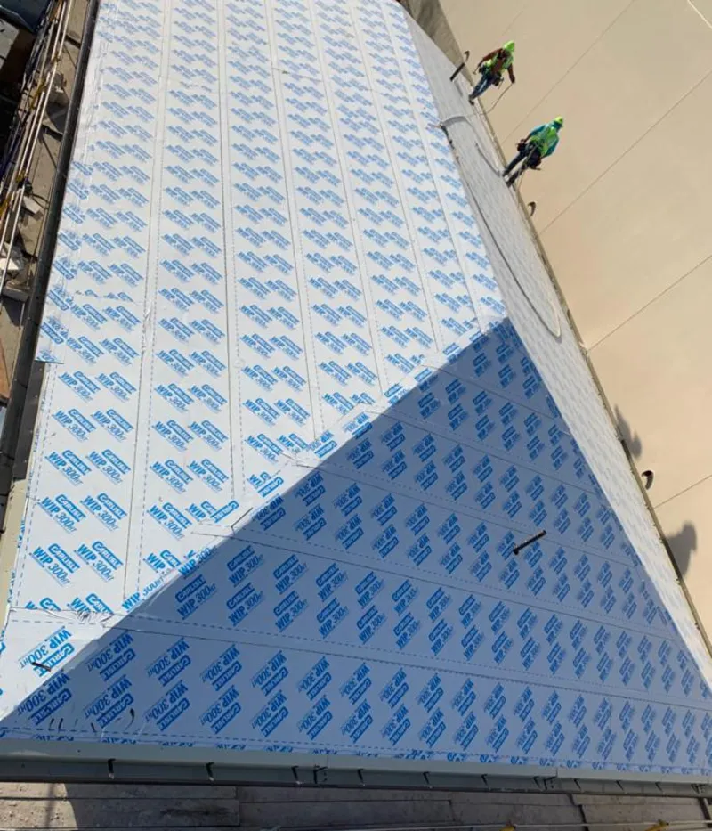 Professional roofers installing underlayment on a metal roof in Elmira